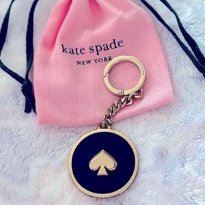 Kate Spade: Gold Enamel; Black accent
Spade keychain/purse charm w/clip closure.